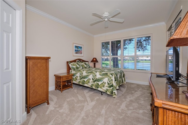 carpeted bedroom with ceiling fan and ornamental molding