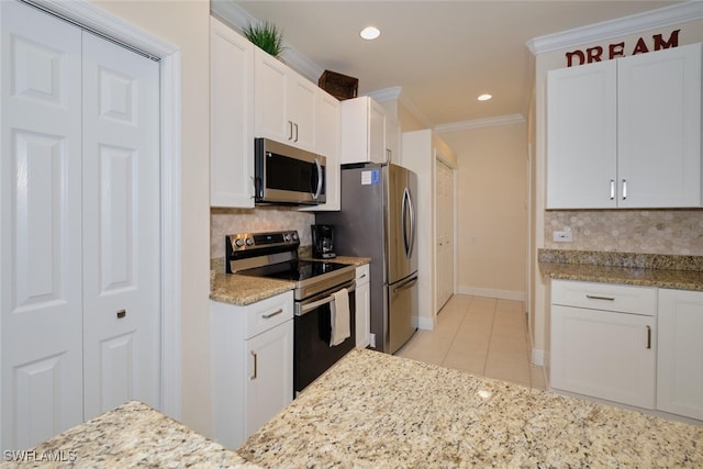 kitchen with white cabinets, backsplash, light tile patterned flooring, and stainless steel appliances