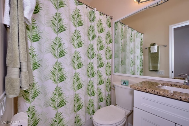 bathroom featuring toilet and vanity