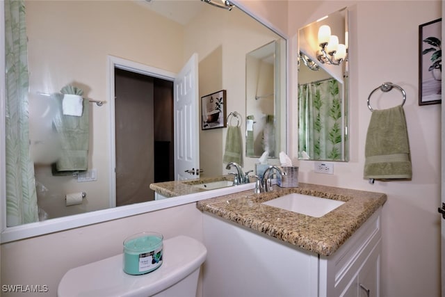 bathroom featuring toilet and vanity