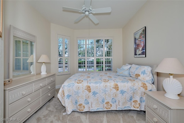 bedroom with ceiling fan and light colored carpet