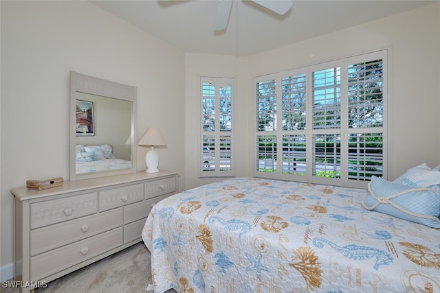 bedroom with ceiling fan and light colored carpet