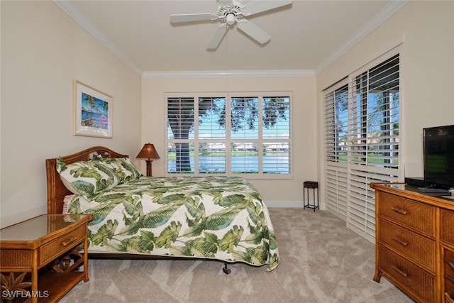 carpeted bedroom with ceiling fan, crown molding, and multiple windows