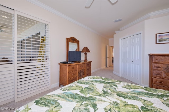 bedroom with ceiling fan, light colored carpet, a closet, and crown molding