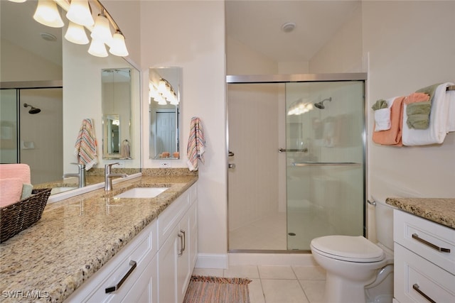 bathroom with vanity, toilet, tile patterned flooring, and walk in shower