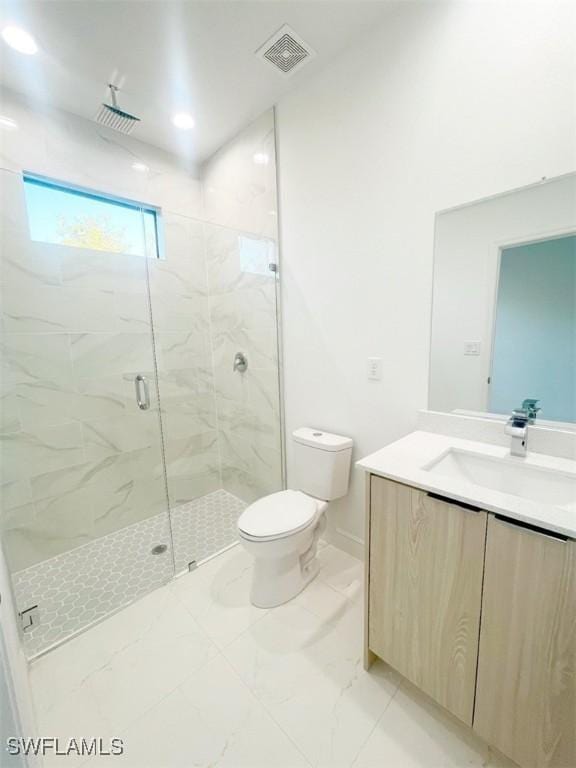 bathroom with toilet, vanity, visible vents, marble finish floor, and a marble finish shower