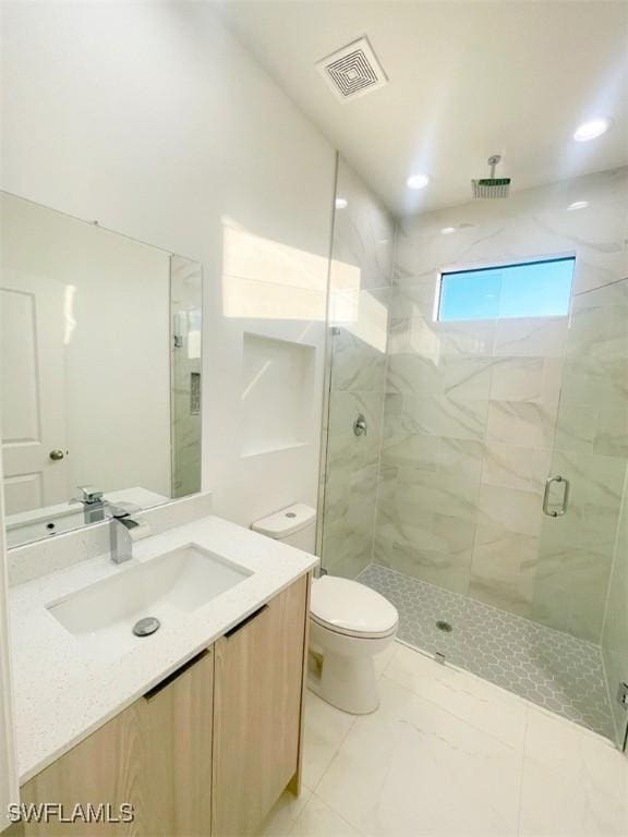 full bath featuring marble finish floor, a marble finish shower, visible vents, toilet, and vanity