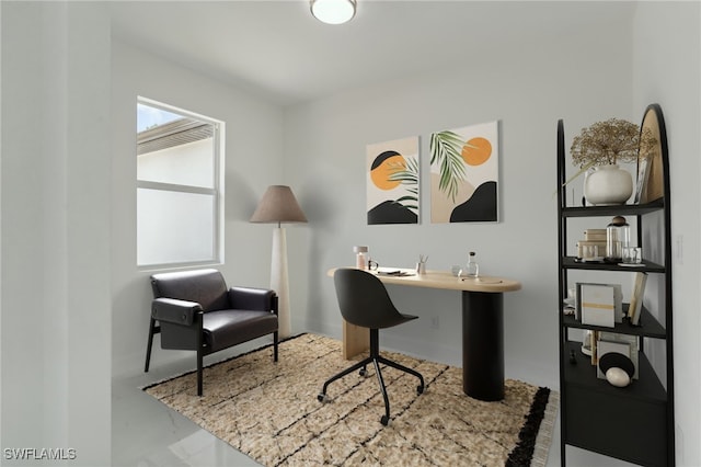 home office featuring concrete flooring