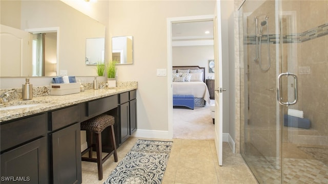 bathroom with tile patterned floors, walk in shower, and vanity