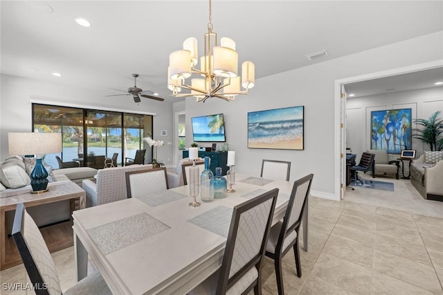 dining area featuring light tile patterned floors and ceiling fan with notable chandelier