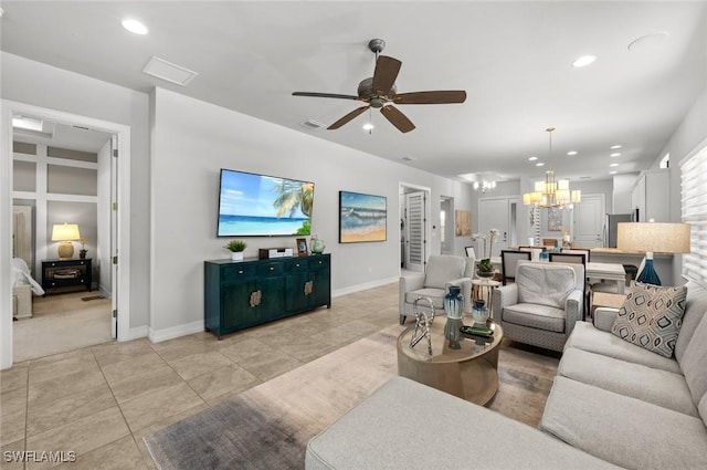 living room with light tile patterned flooring and ceiling fan with notable chandelier