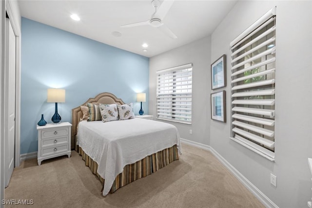 carpeted bedroom with ceiling fan and a closet