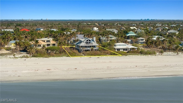 drone / aerial view featuring a view of the beach and a water view