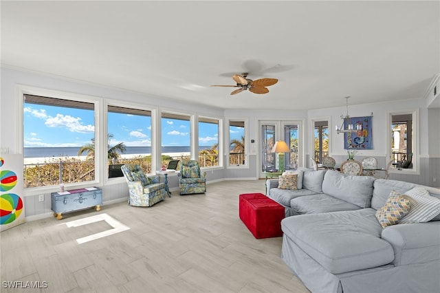 living room featuring ceiling fan and a water view