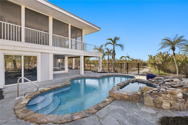 view of pool with a patio area and an in ground hot tub