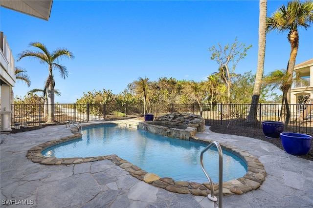 view of pool with pool water feature and a patio