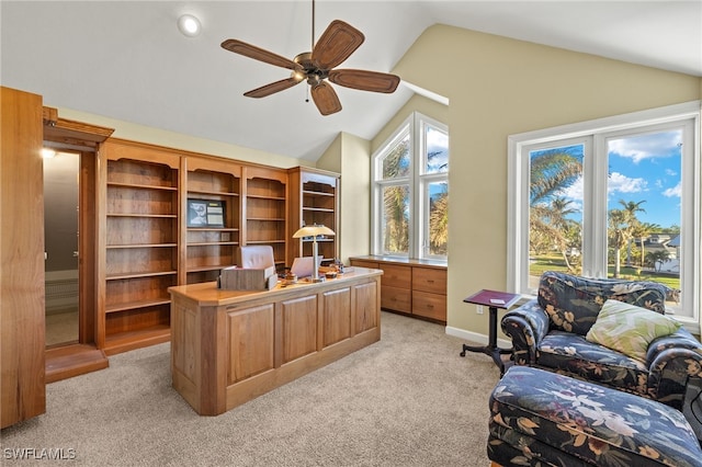 home office with ceiling fan, lofted ceiling, and light colored carpet