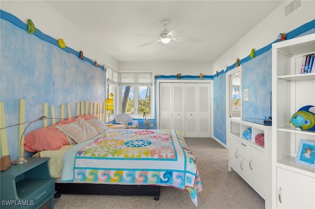 carpeted bedroom with ceiling fan and a closet