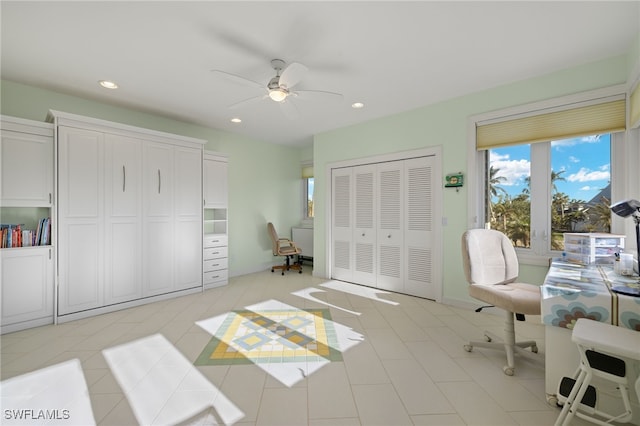 office space featuring ceiling fan and light tile patterned floors