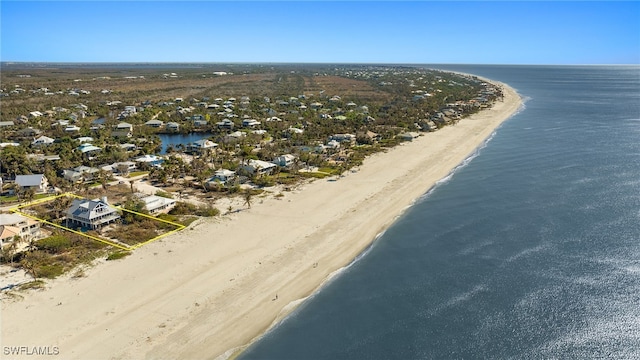 bird's eye view with a water view and a beach view