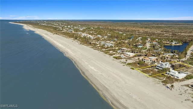 birds eye view of property with a water view and a view of the beach