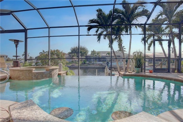 outdoor pool with glass enclosure, a patio, and an in ground hot tub