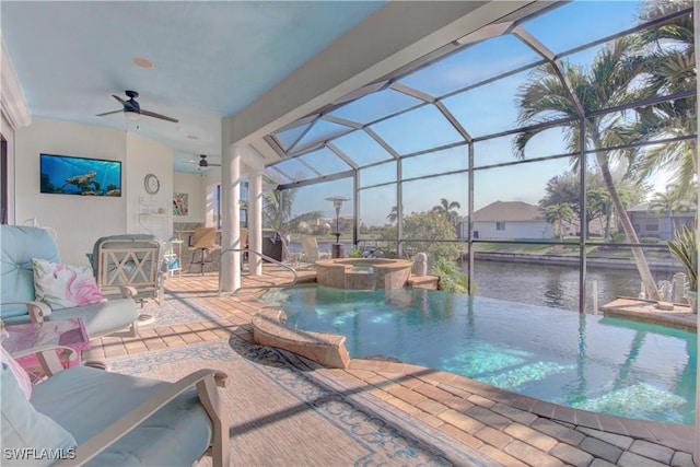 view of swimming pool with a water view, glass enclosure, a ceiling fan, and a patio