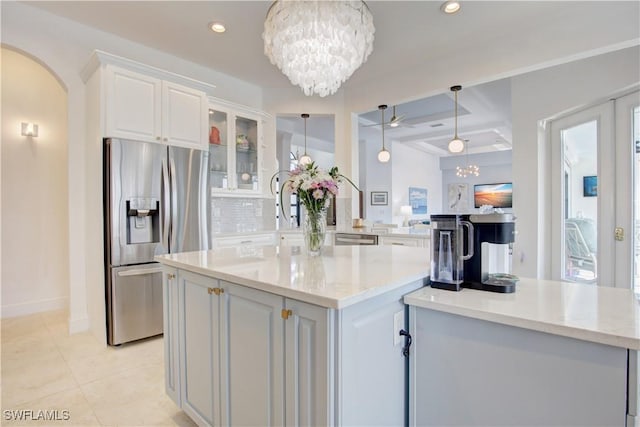 kitchen with a center island, tasteful backsplash, appliances with stainless steel finishes, glass insert cabinets, and white cabinets