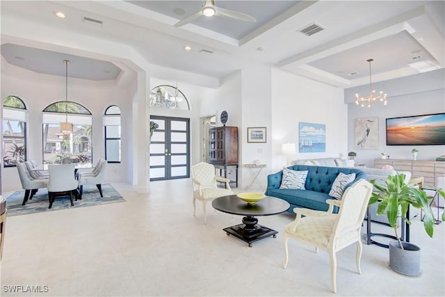 living room featuring french doors, a raised ceiling, and visible vents