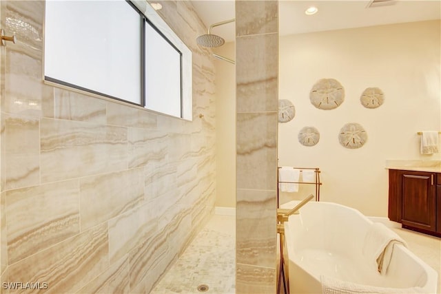 bathroom with a freestanding tub, a tile shower, and recessed lighting