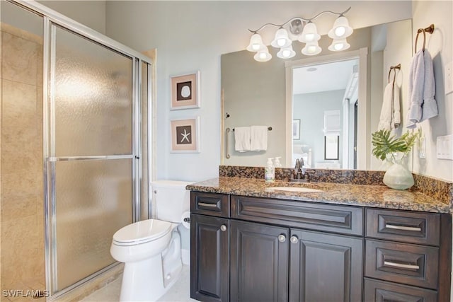 full bath with a stall shower, vanity, and toilet