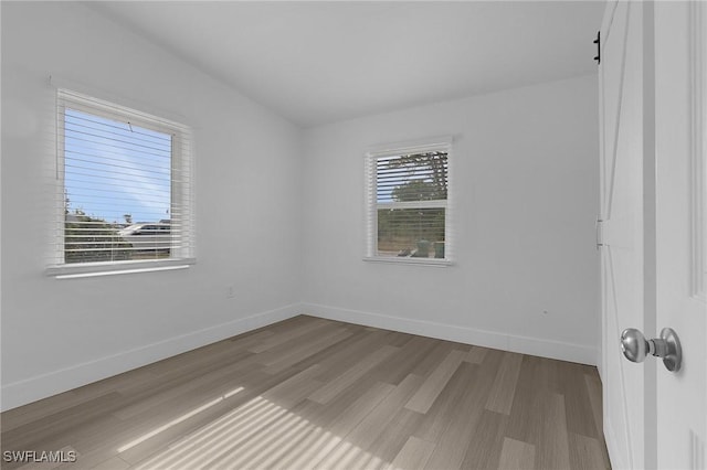 unfurnished room featuring wood finished floors and baseboards