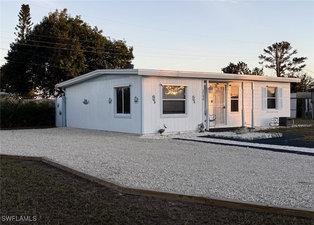 view of front of home featuring driveway and central AC unit