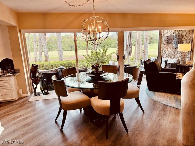 dining room with light wood-style flooring and an inviting chandelier