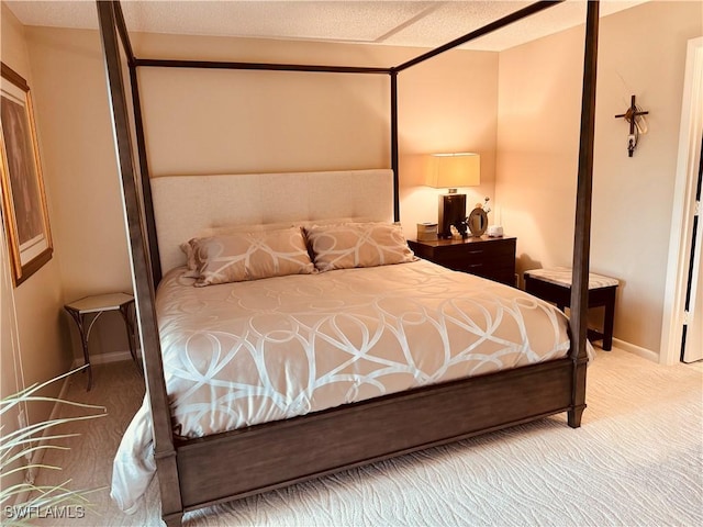 bedroom featuring carpet and baseboards