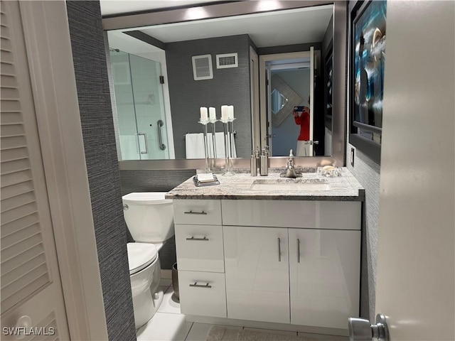 full bath with visible vents, toilet, an enclosed shower, vanity, and tile patterned floors