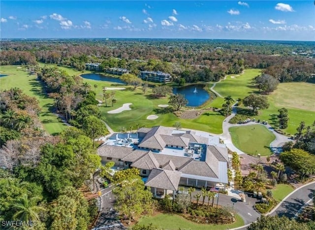 bird's eye view featuring a water view, a wooded view, and golf course view