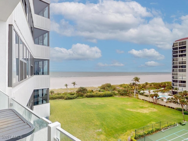 view of yard featuring a beach view and a water view