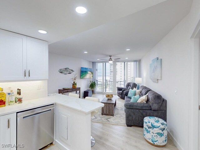 living room featuring light hardwood / wood-style floors and ceiling fan