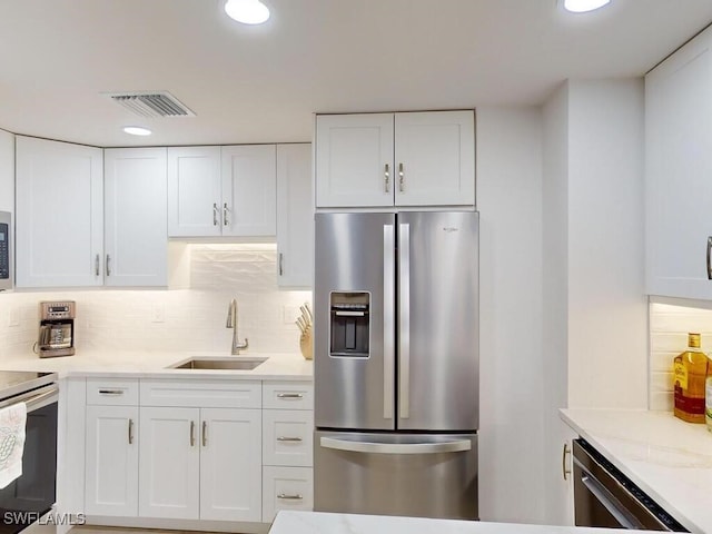 kitchen with white cabinets, stainless steel appliances, and sink