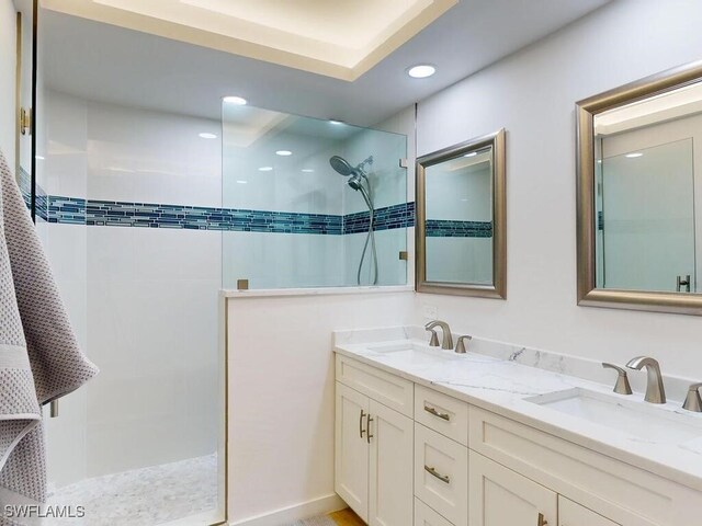 bathroom featuring vanity and tiled shower