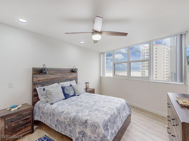 bedroom with ceiling fan and light hardwood / wood-style flooring