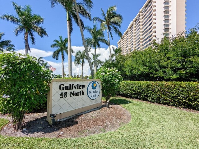 community / neighborhood sign with a lawn