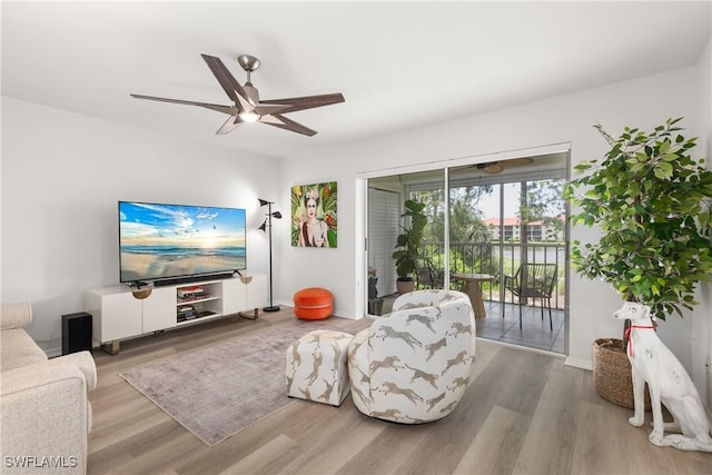 living room with ceiling fan and hardwood / wood-style flooring