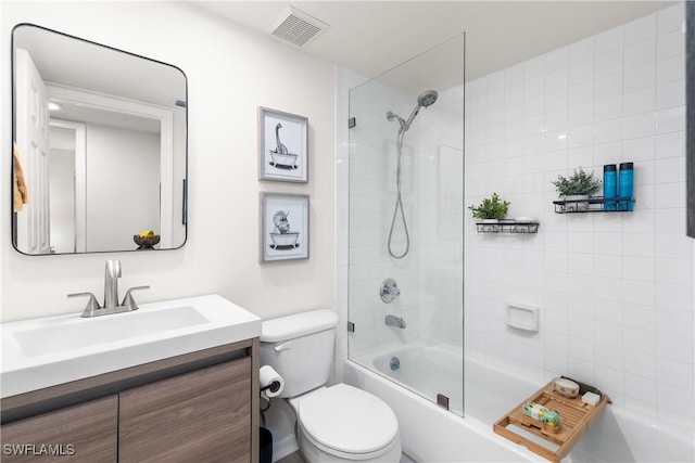 full bathroom with toilet, tiled shower / bath, and vanity