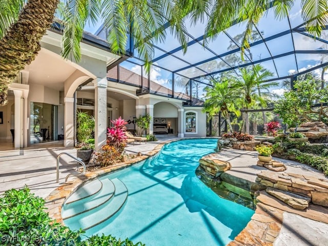 view of pool featuring a patio and glass enclosure