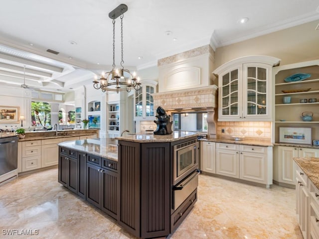 kitchen featuring sink, appliances with stainless steel finishes, dark brown cabinets, light stone countertops, and an island with sink