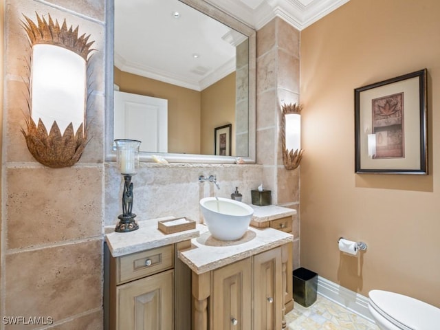 bathroom with ornamental molding, toilet, and vanity