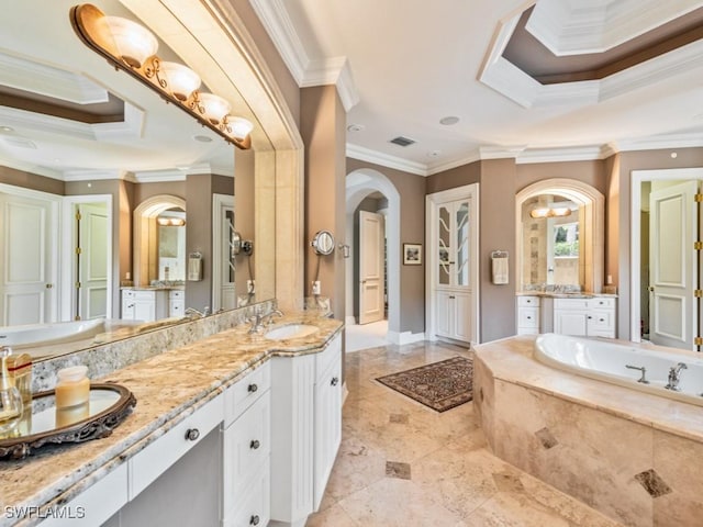 bathroom featuring ornamental molding, vanity, and tiled tub