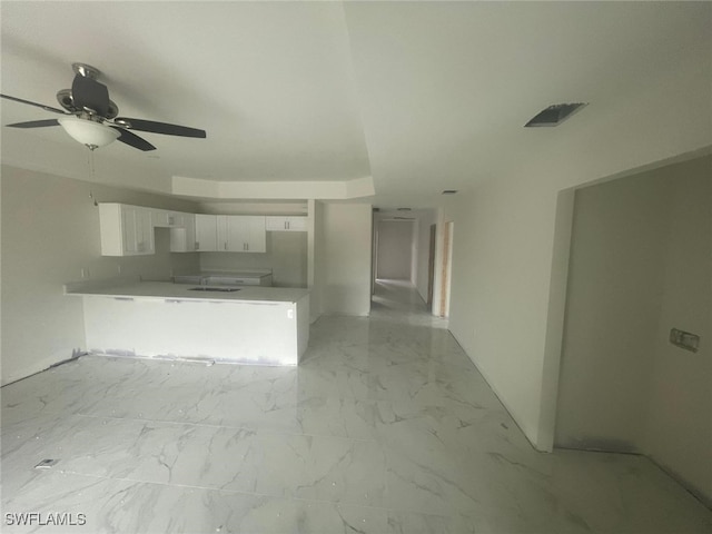 unfurnished living room featuring ceiling fan